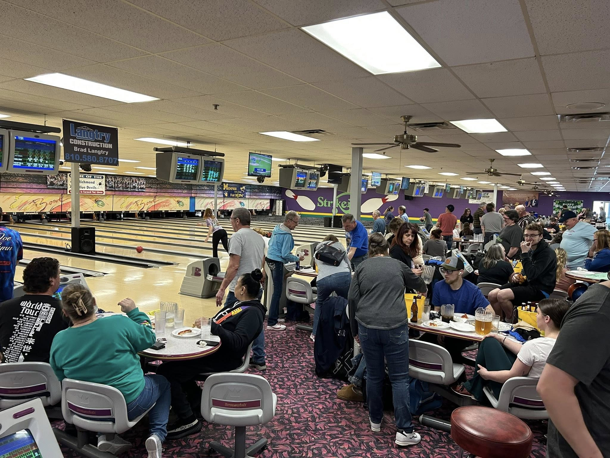 Guests bowling during a league night at Strikers